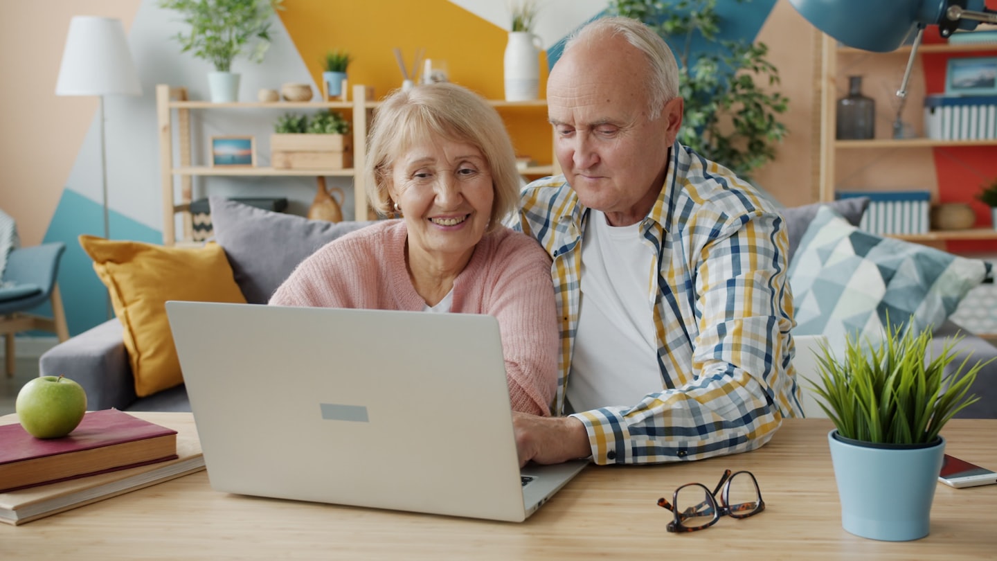 Retired couple reviewing their pensions on a laptop. State Pension 2026. Retirement Adviser UK